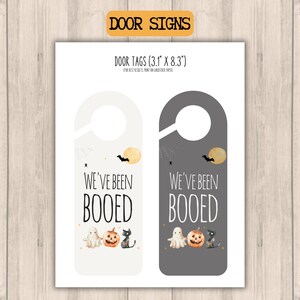 two different halloween weve been booed door signs