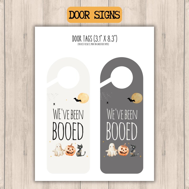 two different halloween weve been booed door signs