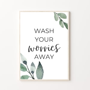 May include: A white printable sign with the text "Wash your worries away" in black text. The sign is decorated with watercolour green leaves in the corners.