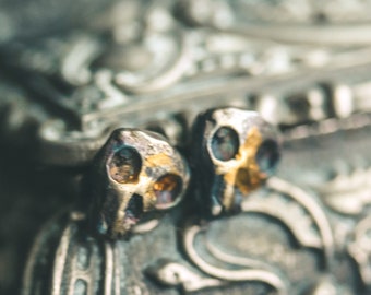 Skull Stud Earrings: A Symbol of Mortality, Strength, and Rebirth