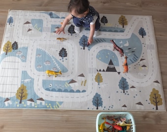 May include: A blue and white play mat with a road and animal illustrations. A child is playing with toy animals on the mat.