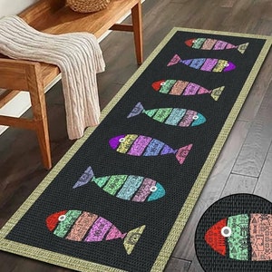May include: A black and beige runner rug with a colorful fish design. The rug has a fringe border and features a repeating pattern of fish with rainbow scales.
