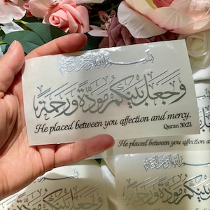 May include: A white ceramic mug with a black handle and the text "But First, Coffee" in a handwritten style. The mug is on a white surface. The mug is likely for hot beverages.