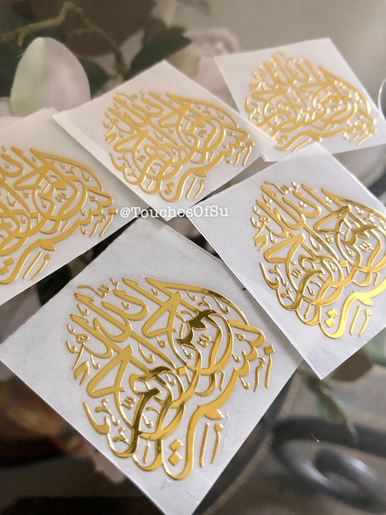May include: Five gold foil stickers with Arabic calligraphy on a white background. The text on the stickers reads "@TouchesOfSu".