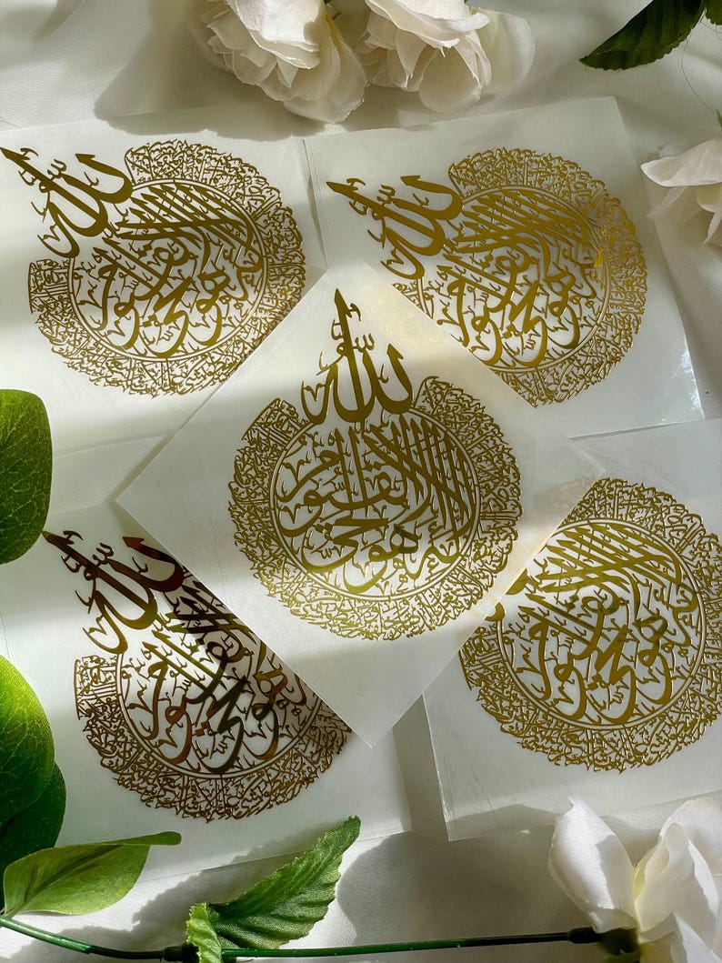May include: Five gold foil stickers with Arabic calligraphy in a circular design. The stickers are on a white background.