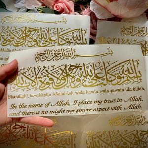 May include: A white ceramic mug with a black handle and the text "But First, Coffee" in a bold, black font. The mug is set against a blurred background, suggesting a cozy setting.