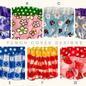 May include: A collection of punch cover designs with various patterns. Designs include purple with rainbows, pink with flowers, blue with ladybugs, purple with flowers, blue with white polka dots, red and yellow gingham, and pink with strawberries.