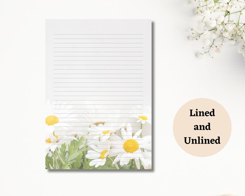 May include: White lined notepad with a daisy floral design at the bottom. The daisies have white petals and yellow centres. The text "Lined and Unlined" is in a beige circle.