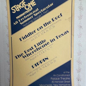 May include: A vintage poster advertising a summer spectacular featuring the musicals "Fiddler on the Roof", "The Best Little Whorehouse in Texas", and "Pippin". The poster is yellow with blue text and features the dates and times of the performances. The poster is for the Air Conditioned Palace Theatre in Manchester, New Hampshire.