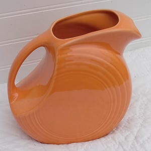 Tangerine Lg. Fiesta disk pitcher/ Fiesta pitcher/ Pitchers/ Fiesta tangerine pitcher/ Fiesta pitchers/Large disk pitcher/ Fiesta ware