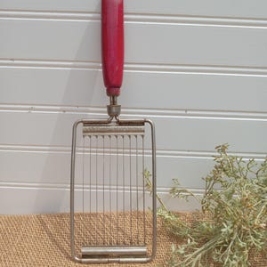 vintage red handle utensil/ vintage utensil/ old kitchen tool/ vintage red handle cutting tool
