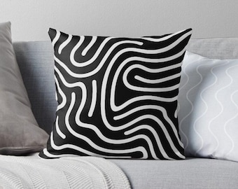 May include: Black and white throw pillow with a wavy, abstract pattern. The pattern is made up of white lines on a black background.