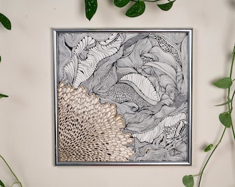 May include: Abstract black and white artwork in a silver frame. The artwork features intricate line drawings with a textured, fan-like design in the lower left corner. Green vines with heart-shaped leaves frame the artwork.
