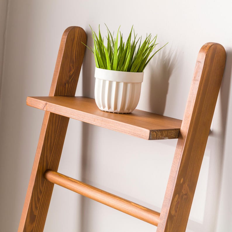 We combine the blanket ladder wood and blanket storage bathroom ladder wood  as a spacesave furniture. Here is designer towel rack ladder with plant stand farmhouse living room for your home!