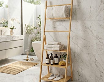 May include: A light-colored wooden ladder shelf featuring four horizontal rungs and shelves. The top rung holds a rolled white towel, the middle shelves contain folded white towels and various dark-colored bottles, and the bottom shelf holds slippers.