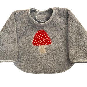 Bib with sleeves light blue with red mushroom