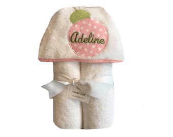 May include: White hooded towel with a pink and white polka dot strawberry design. The towel is embroidered with the name "Adeline".