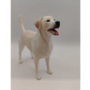 May include: A white Labrador Retriever figurine with a black nose and open mouth. The figurine is standing on a white surface.