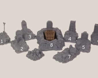 May include: A set of nine miniature grey resin graveyard tombstones and grave markers numbered 1 to 9. The tombstones are on a white background.