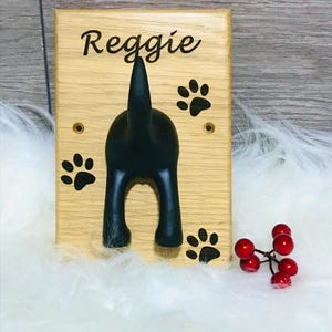Solid Oak Board with a black rubber dog tail hook personalised with name and paw prints