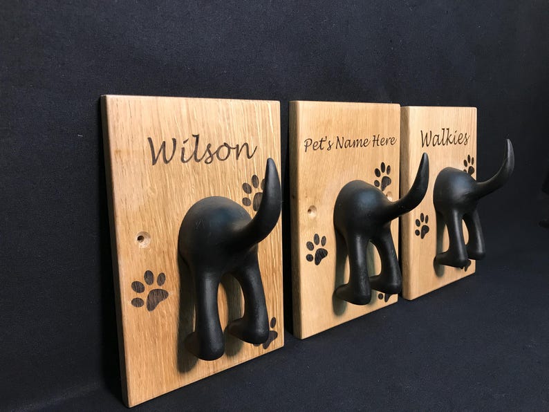 Solid Oak Board with a black rubber dog tail hook personalised with name and paw prints