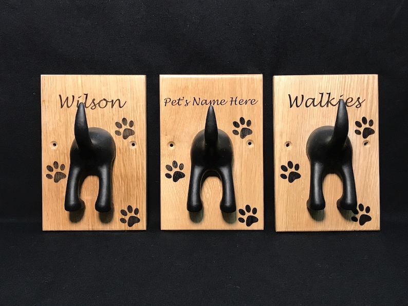 Solid Oak Board with a black rubber dog tail hook personalised with name and paw prints