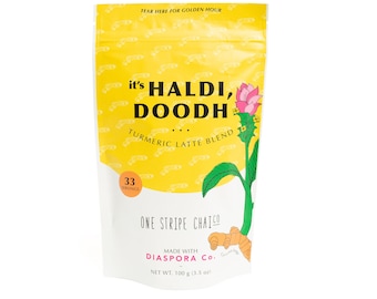 May include: A yellow pouch with a white label that says "it's HALDI, DOODH TURMERIC LATTE BLEND" and features a yellow flower. The label also says "33 SERVINGS ONE STRIPE CHAICO MADE WITH DIASPORA Co. NET WT. 100 g (3.5 oz)"