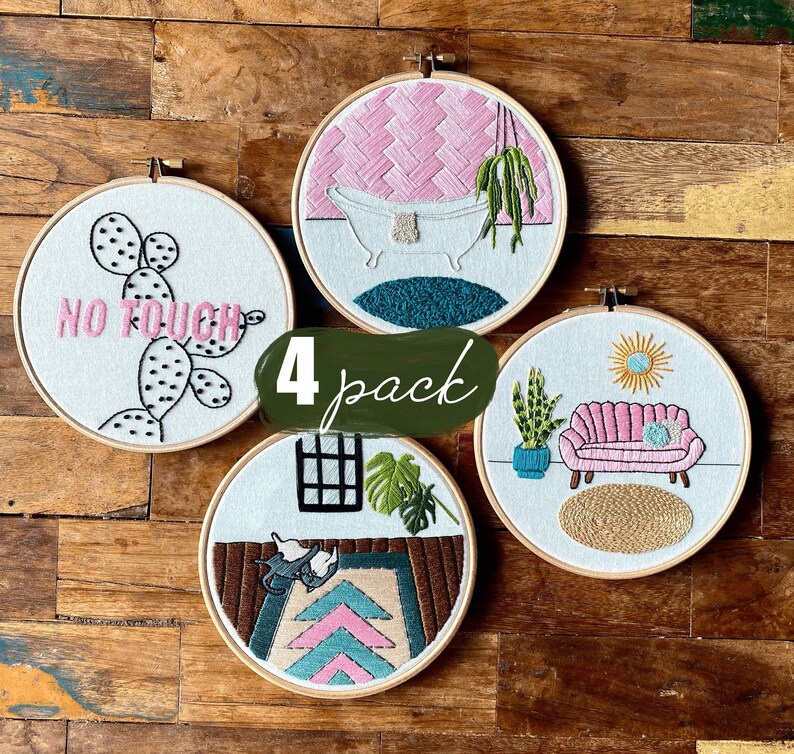 May include: Set of four embroidered hoop art pieces with various designs. The designs include a cactus with the text "No Touch", a bathtub with a plant, a sofa with a plant and a sun, and a rug with a plant and a window.