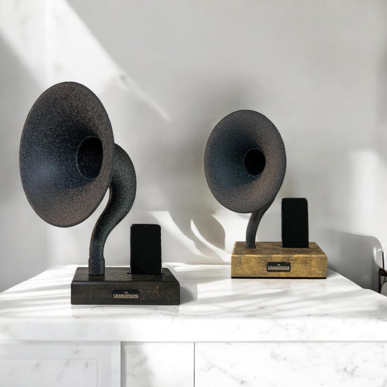 May include: Two vintage-style gramophone speakers with black and brown finishes. Each speaker has a black phone stand and a wooden base with the text "The Gramophone" on it.