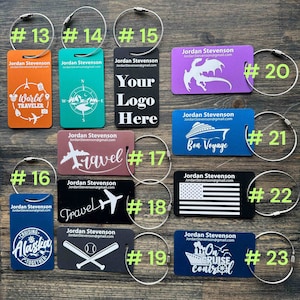 May include: Ten different luggage tags with various designs and colors. The tags are made of metal and have a silver ring attached to them. The designs include a world traveler, a compass, a dragon, a cruise ship, a plane, a baseball bat and ball, a state flag, and the words "Travel" and "Bon Voyage".