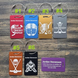 May include: Six different luggage tags with a hockey theme. The tags are made of metal and have a variety of designs, including a hockey stick and puck, a hockey helmet, and a hockey player. The tags are all personalized with the name "Jordan Stevenson".