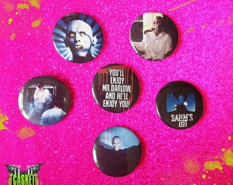 May include: Five round button pins featuring images and text from the horror film Salem's Lot. The pins feature a vampire, a man in a white shirt, a scene from the film, the text "You'll enjoy Mr. Barlow, and he'll enjoy you!" and the Salem's Lot logo.