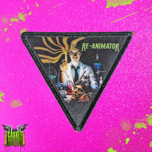 May include: A triangular black patch with a white border. The patch features a colorful image of a scientist holding a test tube and a severed head. The text "RE-ANIMATOR" is printed in white at the top of the patch.
