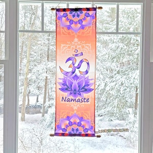 May include: A tapestry with an orange and purple mandala design featuring the Om symbol and the word "Namaste".