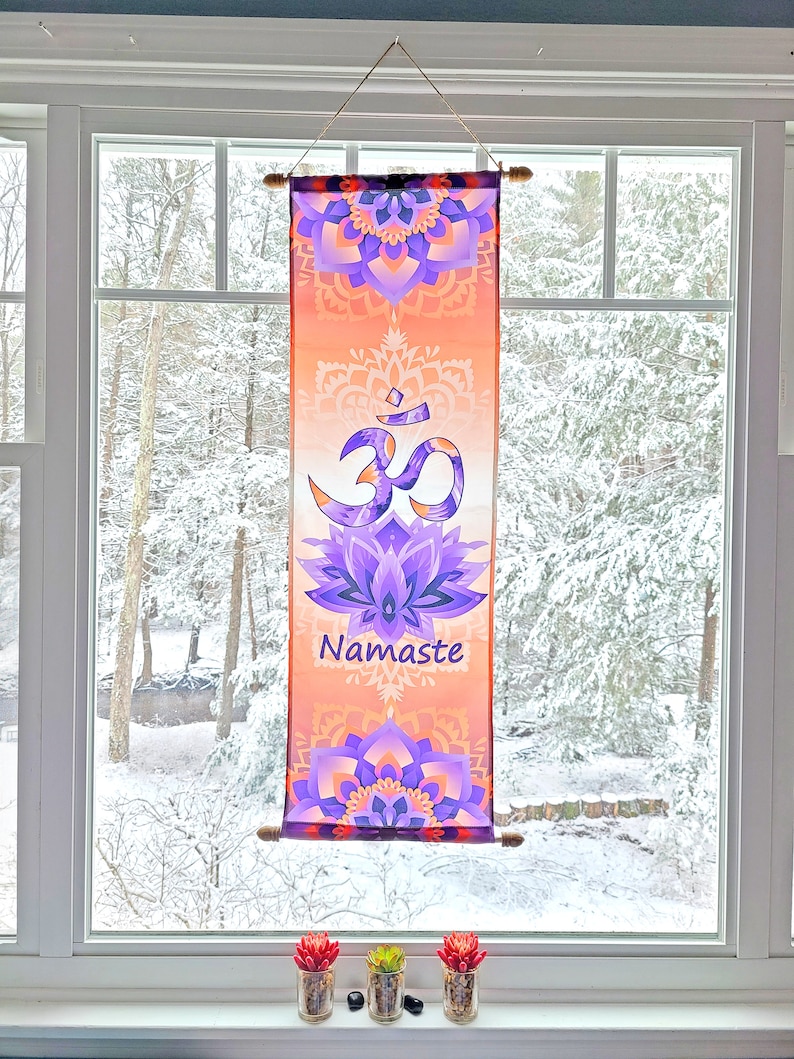 May include: A tapestry with an orange and purple mandala design featuring the Om symbol and the word "Namaste".