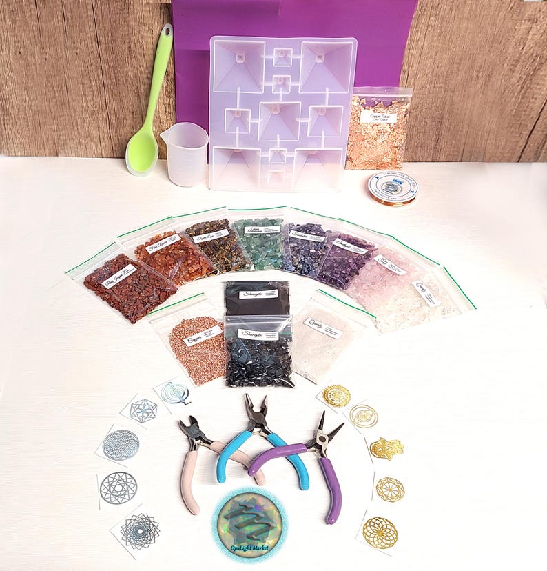 May include: A craft kit for making crystal pyramids includes a variety of colored crystals, a silicone mold, wire, pliers, and a set of geometric stencils.