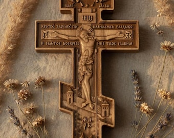 May include: A detailed wooden Orthodox cross with intricate carvings. The cross features a central figure and inscriptions in a foreign language. The cross is a warm brown color and is surrounded by dried flowers and foliage.