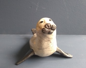 Seal, Raku fired. Each piece is hand made and very individual.