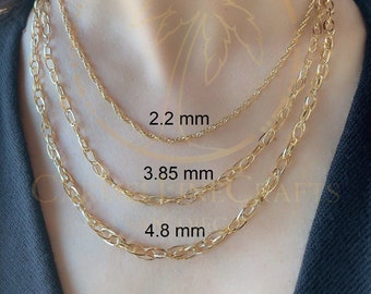 May include: Three gold chains of different thicknesses, worn on a person's neck. The chains are labeled with their widths in millimeters: 2.2 mm, 3.85 mm, and 4.8 mm.