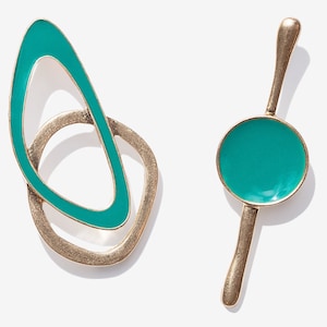May include: A pair of teal blue and gold earrings. One earring is a circle with a teal blue center and the other earring is a double oval shape with a teal blue center.