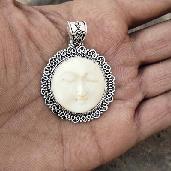 Carved moon hotsell face pendant