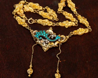 May include: A gold necklace with a pendant featuring a turquoise and pearl design. The necklace is made of a delicate chain with intricate details.
