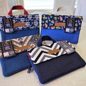 May include: Four small blue denim bags with different fabric patterns on the front flap. Each bag has a red handle and a black tag that says "Stay Positive Good Things".