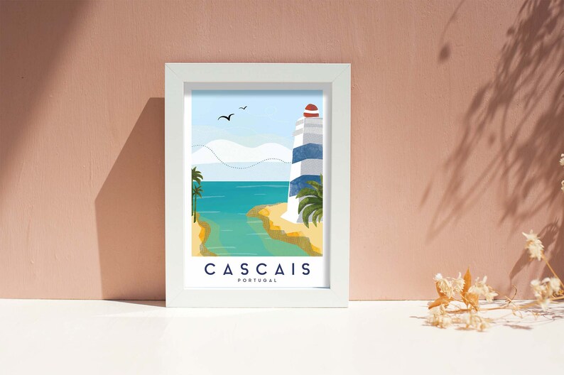 May include: A framed art print featuring a coastal scene with a lighthouse. The illustration depicts a blue and white striped lighthouse, palm trees, and the text "CASCAIS PORTUGAL" in a white frame. The background is a light blue sky and turquoise water.