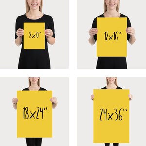 May include: Four yellow posters of varying sizes are held up by a person. The posters are labeled with the dimensions: 8x10", 12x16", 18x24", and 24x36". The text is in a handwritten style, in black ink.