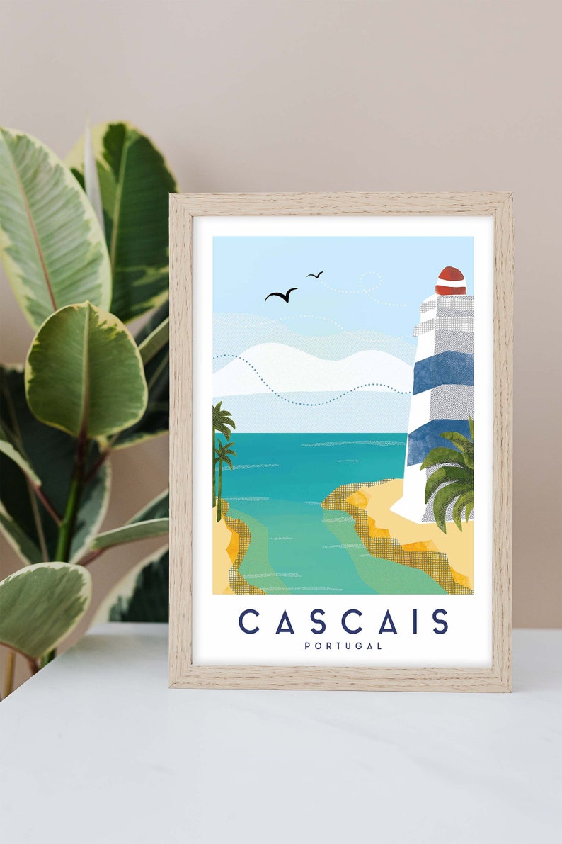 May include: Framed art print featuring a coastal scene with a lighthouse. The lighthouse has blue and white stripes and a red top. The artwork depicts a beach, ocean, and palm trees under a blue sky. The word "CASCAIS" and "PORTUGAL" are printed at the bottom.