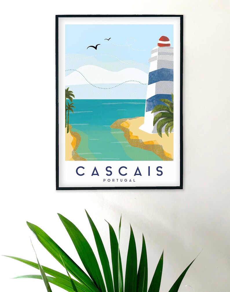 May include: Framed art print featuring a coastal scene with a lighthouse, palm trees, and the text "CASCAIS PORTUGAL." The lighthouse has blue and white stripes and a red top. The artwork depicts a beach and ocean under a blue sky with birds.