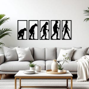 May include: Black metal wall art showing human evolution, presented in five framed panels. The silhouettes depict the stages from ape to modern human. The artwork is displayed above a grey sofa in a living room.