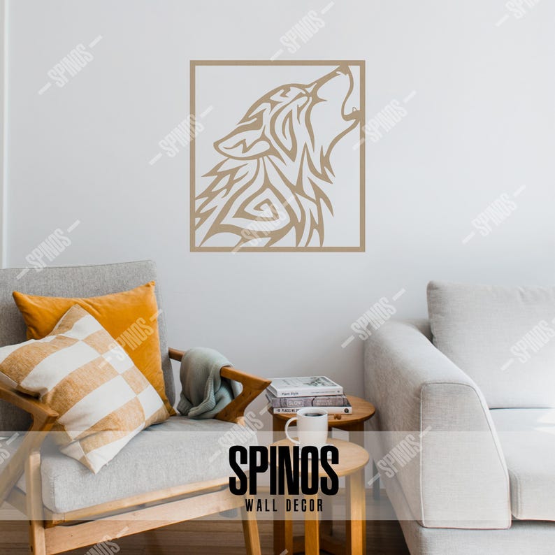 May include: A brown tribal wolf head silhouette wall decal in a square frame. The decal is on a white wall above a light gray couch with pillows. The text "SPINOS WALL DECOR" is on a wooden table in front of the couch.