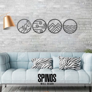 May include: Four black metal wall decor circles with different designs: fire, wind, mountains, and water. The circles are hanging on a white brick wall above a light blue couch with black and white zebra print throw pillows. The text "SPINOS WALL DECOR" is printed below the couch.